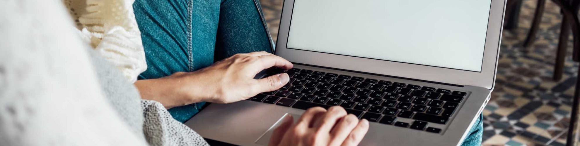 Person sitting on couch with computer